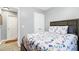 Bedroom featuring a floral quilt, wood-look flooring, and a closet for optimal storage at 1105 Terrace Ct, Raleigh, NC 27615
