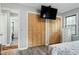 Bedroom featuring closet space with wooden doors, a bed, and sleek vinyl flooring at 1105 Terrace Ct, Raleigh, NC 27615