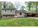 Charming two-story home with a red front door, well-maintained lawn, and covered parking at 1105 Terrace Ct, Raleigh, NC 27615