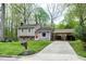 Charming split-level home with a red front door, well-maintained lawn, and a carport at 1105 Terrace Ct, Raleigh, NC 27615