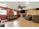 Spacious living room features a brick fireplace, wood flooring, and comfortable leather seating at 1105 Terrace Ct, Raleigh, NC 27615