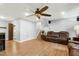Spacious living room with hardwood floors, ceiling fan, stairs, and leather recliner couch at 1105 Terrace Ct, Raleigh, NC 27615