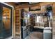 Enclosed patio featuring wood paneling, mini fridge, stools, and a comfortable seating area at 1105 Terrace Ct, Raleigh, NC 27615