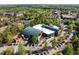 Aerial view of a modern community building with ample parking surrounded by mature trees at 119 Weaver Mine Trl, Chapel Hill, NC 27517