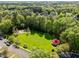 An aerial view of a park with a vast green field, playground, and a charming gazebo at 119 Weaver Mine Trl, Chapel Hill, NC 27517
