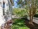 Well-maintained backyard featuring a lush lawn, beautiful landscaping, and a charming white picket fence at 119 Weaver Mine Trl, Chapel Hill, NC 27517