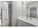 Bright bathroom featuring white cabinets, countertops, stainless steel fixtures and large mirror at 119 Weaver Mine Trl, Chapel Hill, NC 27517