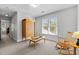 Spacious carpeted bedroom with armoire, coffee table, rocking chair and natural light at 119 Weaver Mine Trl, Chapel Hill, NC 27517