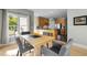 Open dining area adjacent to the kitchen, featuring a simple table and gray modern chairs at 119 Weaver Mine Trl, Chapel Hill, NC 27517
