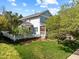 Beautiful two-story home with a well-manicured lawn, mature trees, and a charming white picket fence at 119 Weaver Mine Trl, Chapel Hill, NC 27517