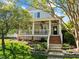Charming two-story home boasts a welcoming front porch and beautifully landscaped front yard at 119 Weaver Mine Trl, Chapel Hill, NC 27517
