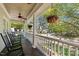 Relaxing front porch featuring rocking chairs, hanging flower baskets, and a ceiling fan at 119 Weaver Mine Trl, Chapel Hill, NC 27517