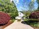 Home featuring a two-car garage, a spacious driveway, and lovely landscaping adding to its curb appeal at 119 Weaver Mine Trl, Chapel Hill, NC 27517