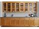 Kitchen features light-colored wood cabinets, glass upper cabinets, and subway tile backsplash at 119 Weaver Mine Trl, Chapel Hill, NC 27517
