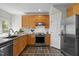 Well-lit kitchen featuring light wood cabinetry, stainless steel appliances, and sleek countertops at 119 Weaver Mine Trl, Chapel Hill, NC 27517