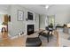 Cozy living room with a fireplace, stylish decor, and comfortable seating arrangements at 119 Weaver Mine Trl, Chapel Hill, NC 27517
