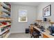 Home office with built-in shelving and drawers, large window and wood laminate desk at 119 Weaver Mine Trl, Chapel Hill, NC 27517