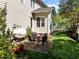 Cozy patio area features a table with four chairs perfect for outdoor dining near the home's exterior at 119 Weaver Mine Trl, Chapel Hill, NC 27517