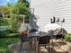 A charming stone patio features a glass table and chairs, with potted plants adding to the inviting outdoor space at 119 Weaver Mine Trl, Chapel Hill, NC 27517