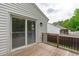 Home's back deck with sliding glass door offers an outdoor retreat with privacy railing and steps to the backyard at 120 Cabrita Ct, Holly Springs, NC 27540