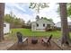 Backyard featuring chairs, fire pit area, wooden deck, patio, storage building and privacy fence for relaxing and gatherings at 120 Cabrita Ct, Holly Springs, NC 27540