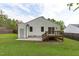 Exterior of home featuring sliding glass door, a wooden deck, outdoor steps, grass, and patio for seamless outdoor living at 120 Cabrita Ct, Holly Springs, NC 27540