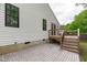 Backyard patio with wood deck and steps combines outdoor living with an adjacent yard area for relaxation and entertainment at 120 Cabrita Ct, Holly Springs, NC 27540