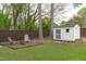 Fenced backyard featuring a storage shed, fire pit area, and lush greenery provides a private outdoor oasis at 120 Cabrita Ct, Holly Springs, NC 27540
