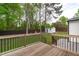 Spacious backyard features a wooden deck, lush lawn, shed, and privacy fence for outdoor enjoyment and storage at 120 Cabrita Ct, Holly Springs, NC 27540