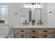 Bathroom featuring double sinks, wood cabinets, and modern fixtures at 120 Cabrita Ct, Holly Springs, NC 27540