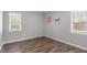 Bedroom featuring two windows and hardwood floors at 120 Cabrita Ct, Holly Springs, NC 27540