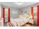 Cozy bedroom featuring gray walls, a white bed frame, and bright red curtains for a pop of color and artistic wall decor at 120 Cabrita Ct, Holly Springs, NC 27540