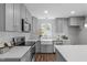 Bright kitchen features stainless appliances, grey cabinets and subway tile backsplash at 120 Cabrita Ct, Holly Springs, NC 27540