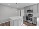 This modern kitchen features stainless appliances, grey cabinets, and lots of counter space at 120 Cabrita Ct, Holly Springs, NC 27540
