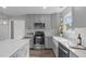 Updated kitchen features stainless appliances, an island and grey cabinetry at 120 Cabrita Ct, Holly Springs, NC 27540