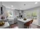 Modern kitchen featuring stainless steel appliances, gray cabinets, and a breakfast bar, offering style and functionality at 120 Cabrita Ct, Holly Springs, NC 27540