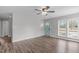 Spacious living room featuring wood-look floors, a ceiling fan, and lots of natural light at 120 Cabrita Ct, Holly Springs, NC 27540