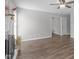 Bright living room featuring wood-look floors, a fireplace, and an open doorway at 120 Cabrita Ct, Holly Springs, NC 27540