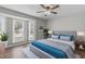 Bright main bedroom featuring a bay window, hardwood floors, and a ceiling fan at 120 Cabrita Ct, Holly Springs, NC 27540