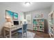 Home office featuring a built-in bookcase, desk, and hardwood floors at 120 Cabrita Ct, Holly Springs, NC 27540