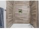 Shower featuring a tile surround, a shower niche, and silver fixtures at 120 Cabrita Ct, Holly Springs, NC 27540