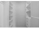 Spacious walk-in closet with custom shelving and built-in drawers at 120 Cabrita Ct, Holly Springs, NC 27540