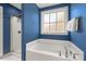 Bathroom boasting a soaking tub under a window, along with a separate glass enclosed shower at 1211 Yellow Wood Dr, Mebane, NC 27302