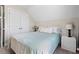 Cozy bedroom featuring neutral tones, a large bed, and bright white closets at 1211 Yellow Wood Dr, Mebane, NC 27302