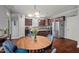 Cozy dining area featuring hardwood floors, lots of light, and a modern kitchen at 1211 Yellow Wood Dr, Mebane, NC 27302