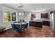 Bright dining area with hardwood floors, ample natural light, and stylish furniture at 1211 Yellow Wood Dr, Mebane, NC 27302