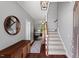 Inviting foyer with hardwood floors, staircase, and elegant decor at 1211 Yellow Wood Dr, Mebane, NC 27302