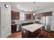 Spacious kitchen featuring granite counters, stainless steel appliances and dark wooden cabinets at 1211 Yellow Wood Dr, Mebane, NC 27302