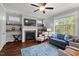 Comfortable living room with fireplace, large windows, and stylish furnishings at 1211 Yellow Wood Dr, Mebane, NC 27302