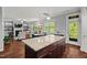 Open concept space with kitchen island overlooking fireplace, dining area and living room at 1211 Yellow Wood Dr, Mebane, NC 27302